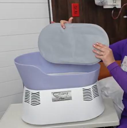 Technician adding gel mat to a Caring Cradle