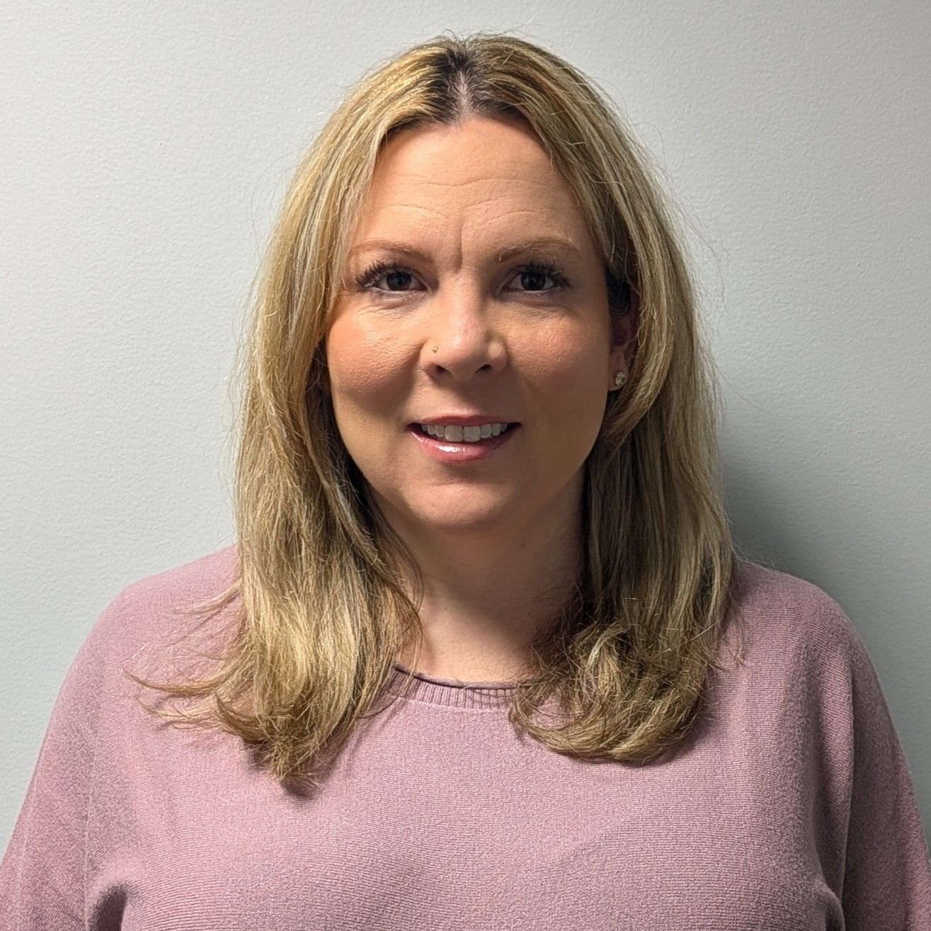 Image of Mary Kait Mace.  A certified Physician Assistant.  Wearing a Black sweater over a cream colored t-shirt.