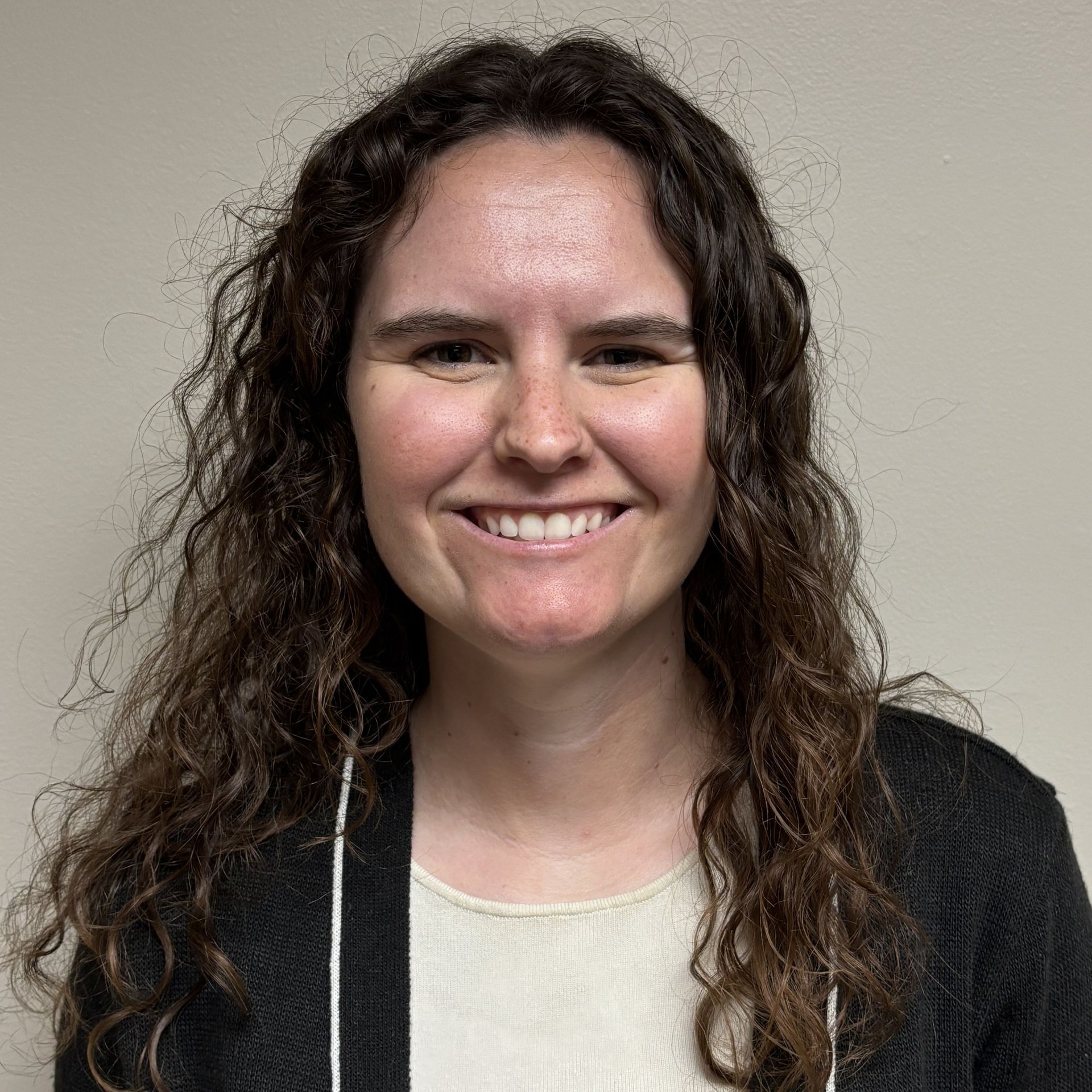 Image of Mary Kait Mace.  A certified Physician Assistant.  Wearing a Black sweater over a cream colored t-shirt.