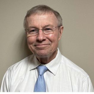 Picture of Dr. Rogers wearing a white shirt with baby blue tie.