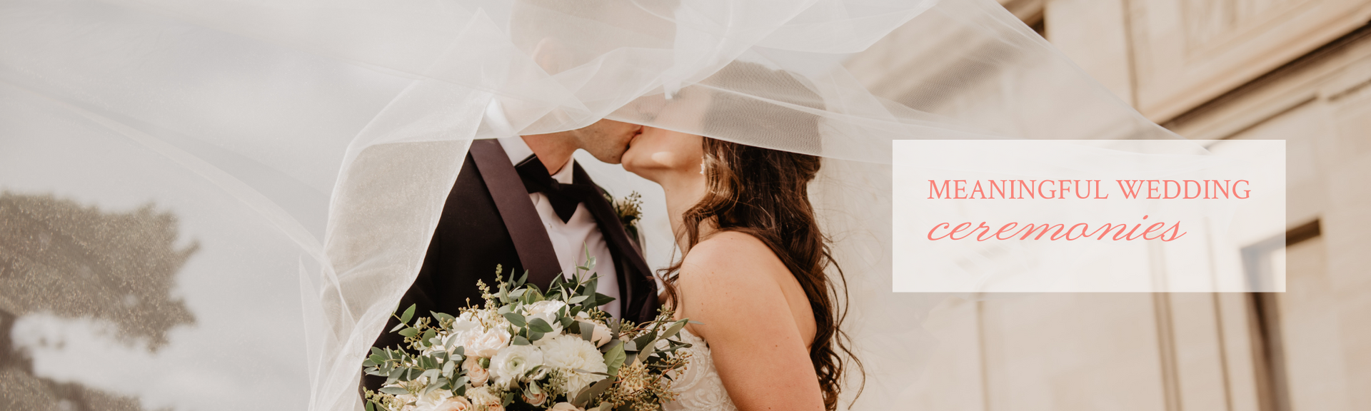 Bride and groom kissing beside a bouquet, with a soft beige wedding invitation banner
