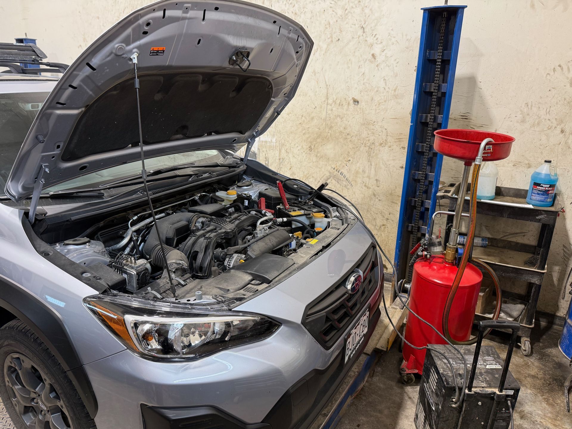 Vehicle being checked in a service bay near mountain roads