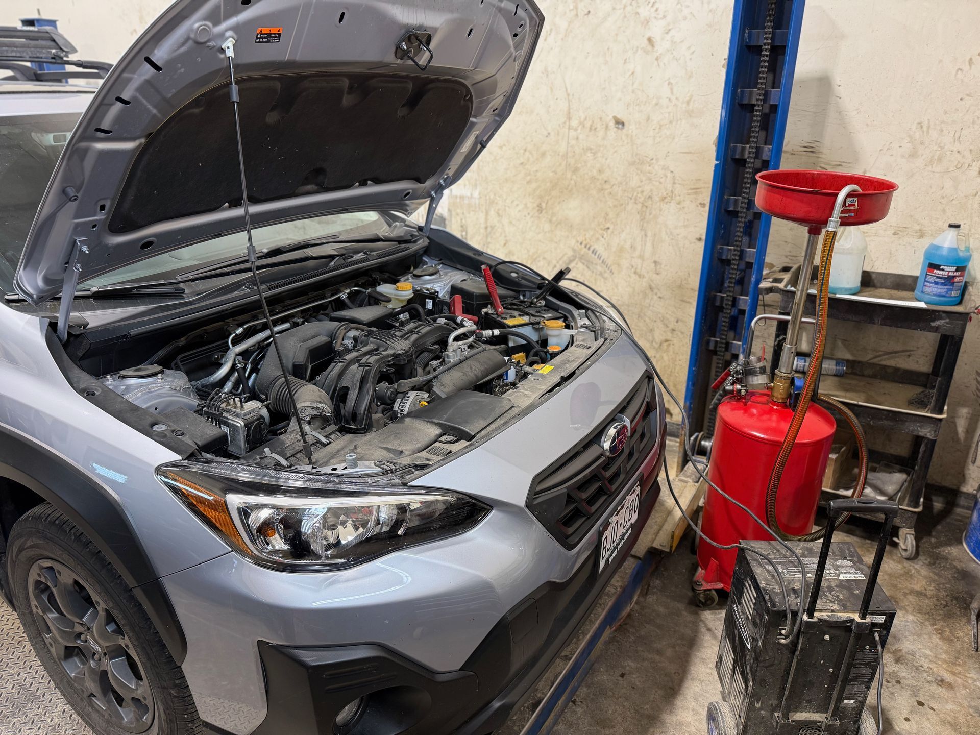 Technician diagnosing vehicle exhaust
