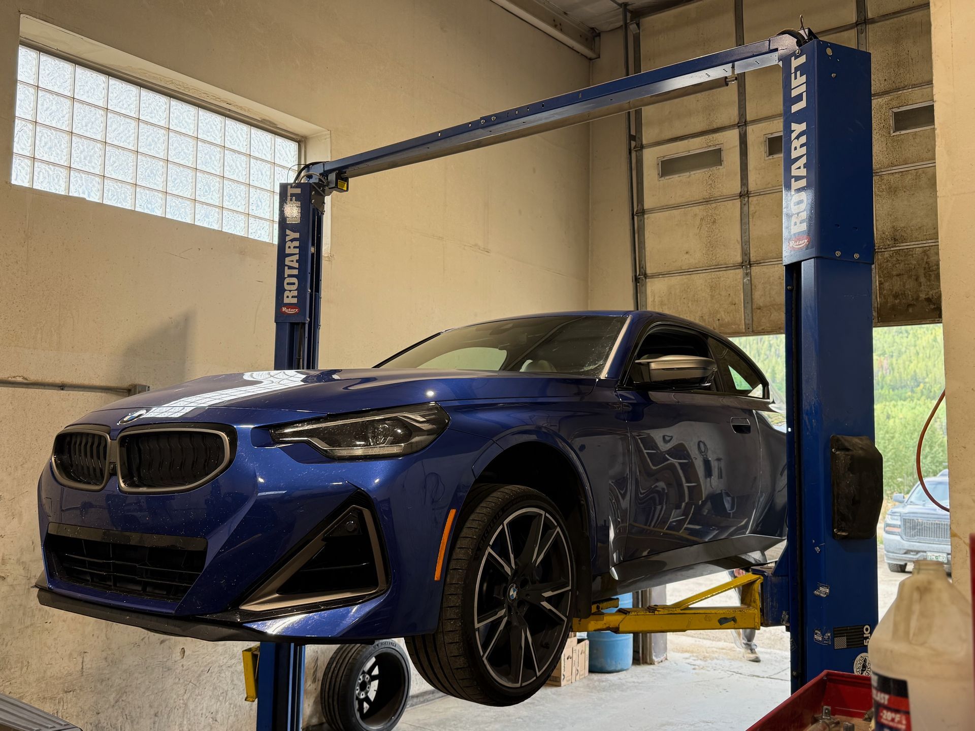 Technician inspecting a brake rotor and caliper