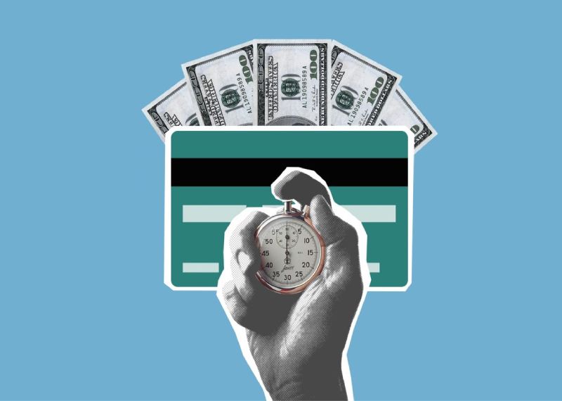 Hand holding stopwatch in front of a credit card and dollar bills, symbolizing time and money.