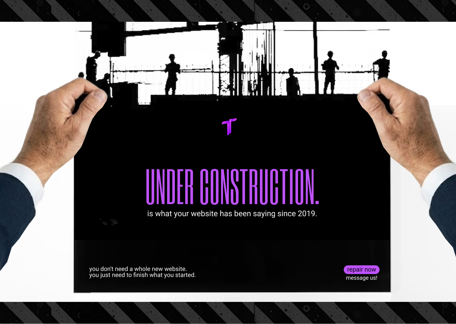 Hands holding a black under-construction poster with purple text and worker silhouettes on scaffolding
