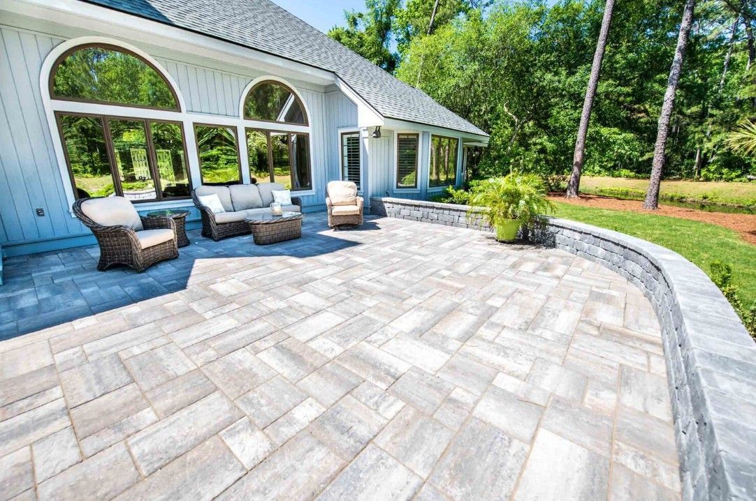 Light colored stone and paver patio with retaining wall