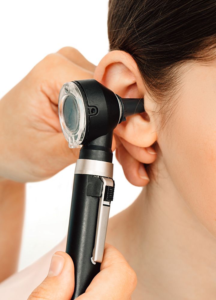Otoscope Examining an Ear During a Medical Checkup — Local Hearing Aid Specialists in Wallsend, NSW