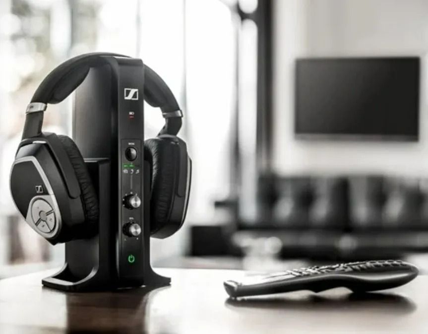 Black Headphones on a Stand Beside a TV Remote — Local Hearing Aid Specialists in Wallsend, NSW