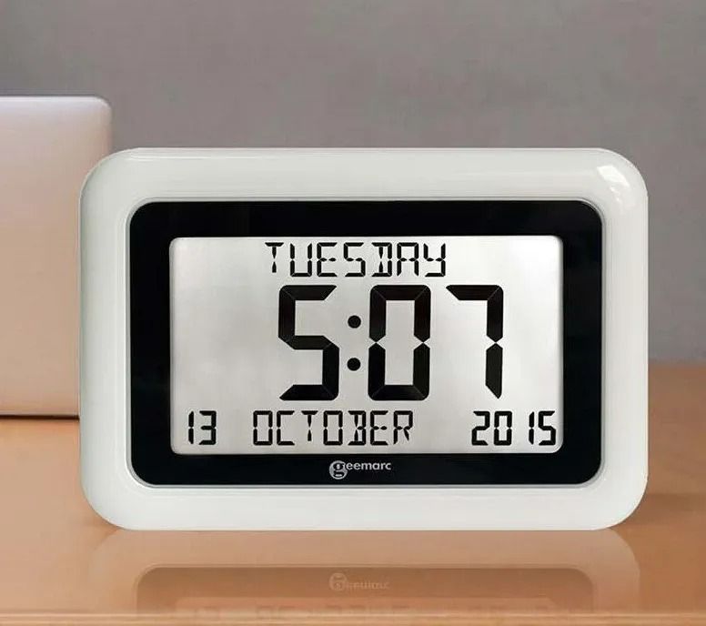 White Digital Alarm Clock on a Wooden Table Showing Tuesday — Local Hearing Aid Specialists in Wallsend, NSW