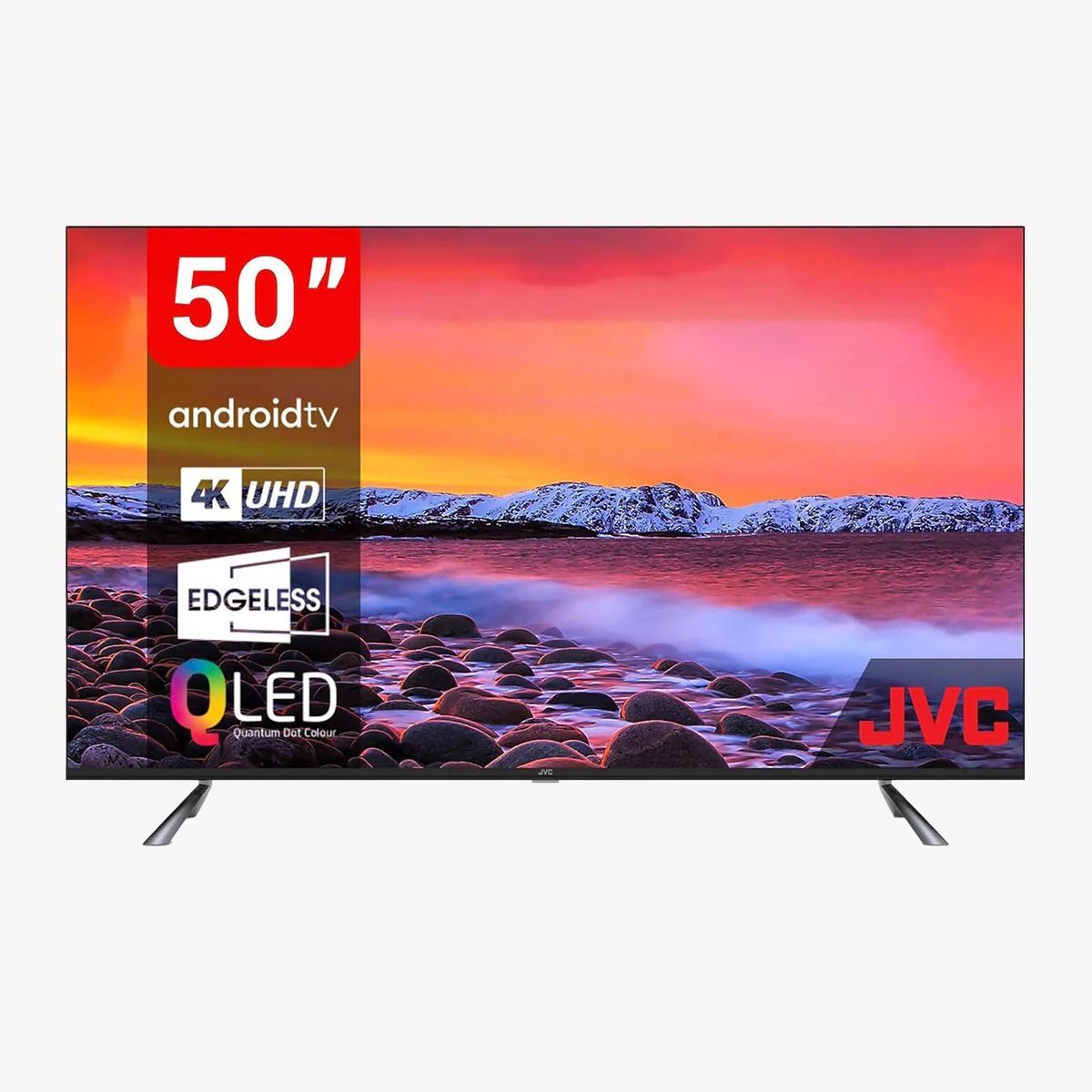Televisor inteligente JVC 4K UHD QLED de 50 pulgadas con pantalla sin bordes sobre soporte plateado, que muestra un paisaje de puesta de sol.