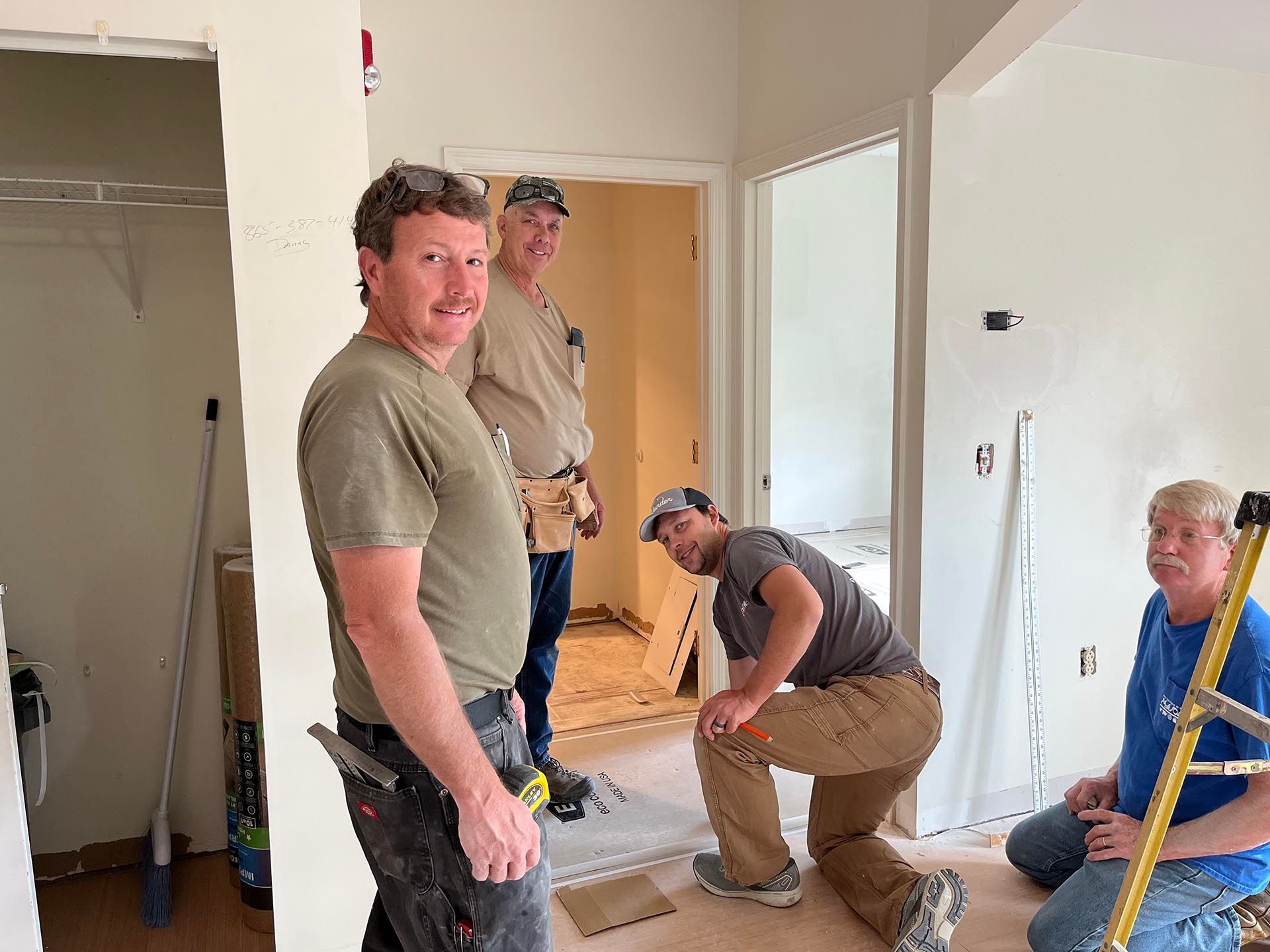 A group of men are working on a house.