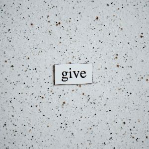 A piece of paper with the word give written on it