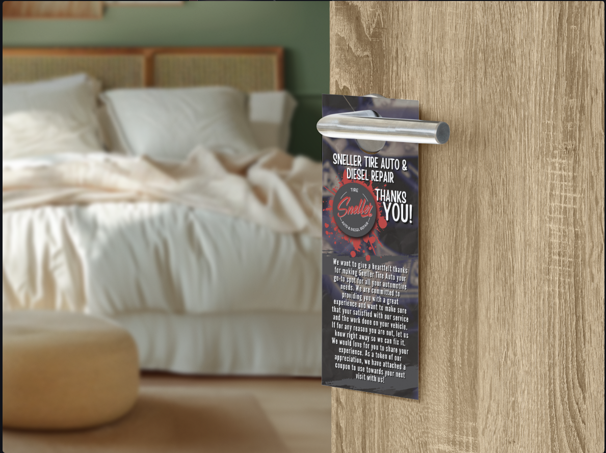 A door hanger with a thank-you message hangs on a modern door handle in a blurred hotel bedroom setting.