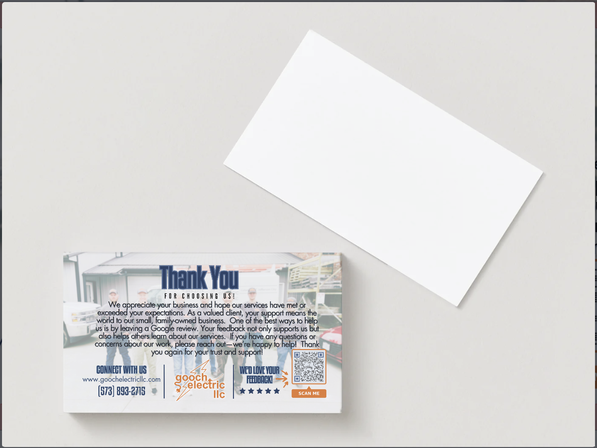 A thank-you note on a white surface, showing a card with business text, icons, and a QR code, with a blank card above it.