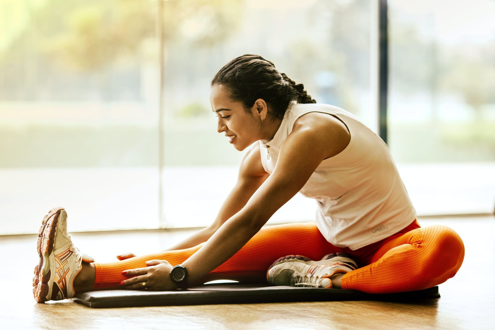 A lady wearing sports clothes is stretching