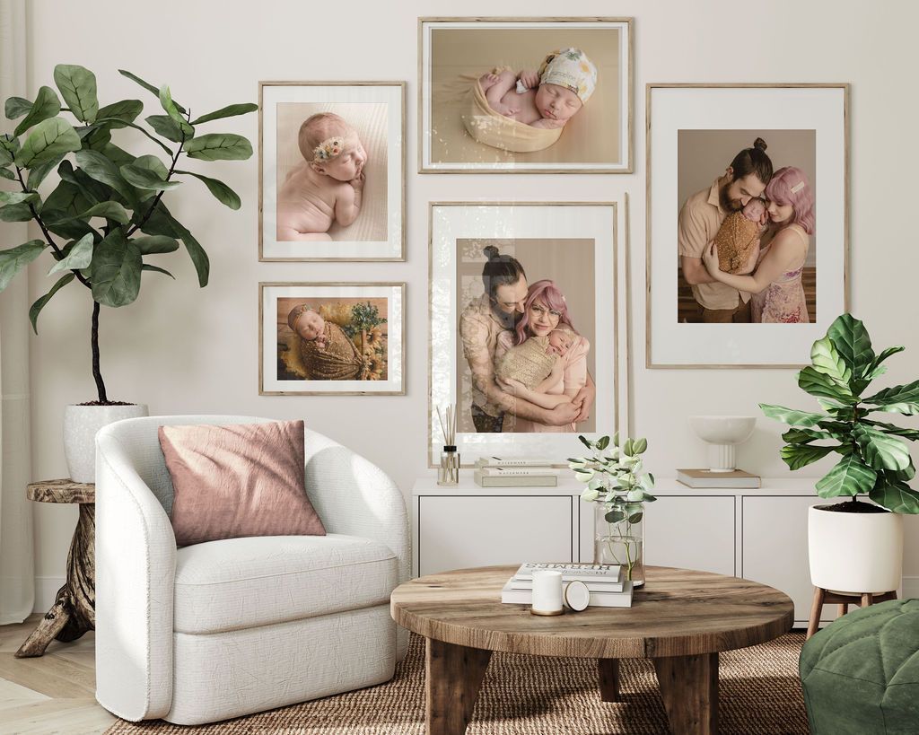 Living room with family photos on a white wall, a white armchair, and a wooden coffee table.