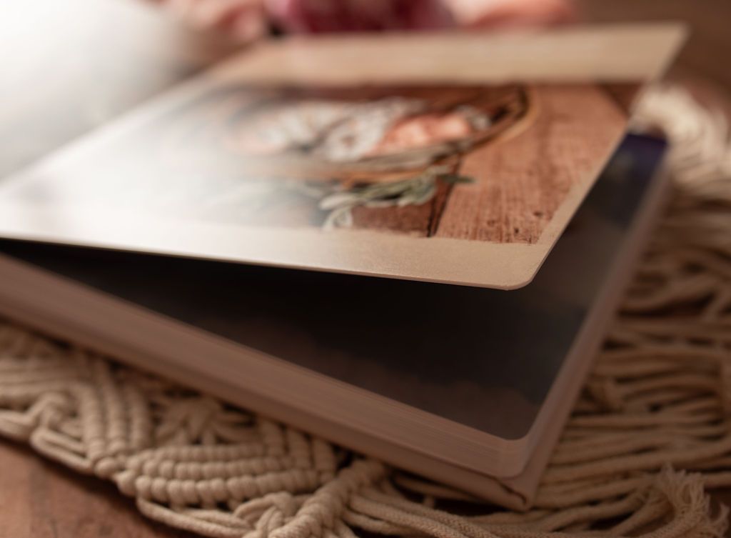 Open cookbook on a macrame coaster; photo of food on wooden surface is visible.