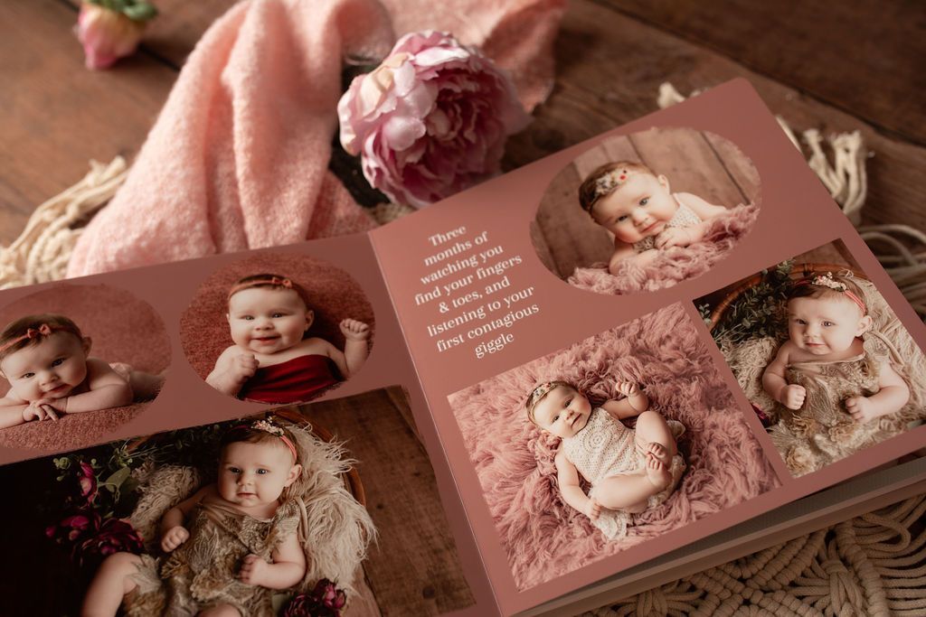 Baby photo album open, showing various portraits of a baby girl on pink pages.