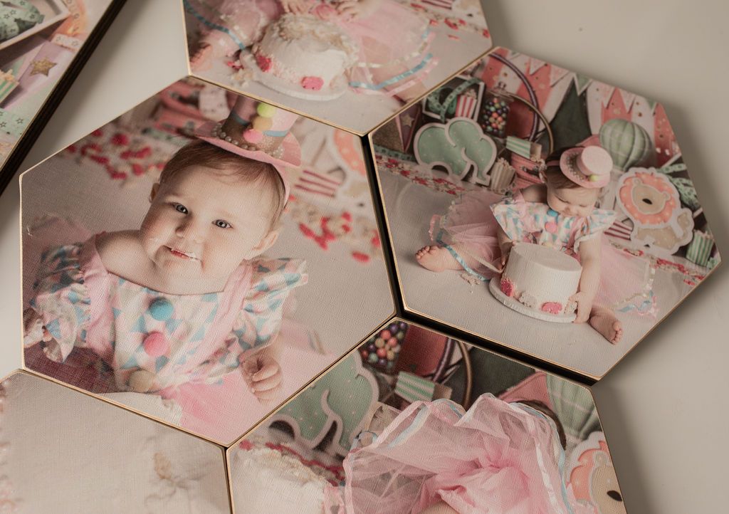 Hexagonal tiles displaying photos of a baby with party decorations; pastel colors.
