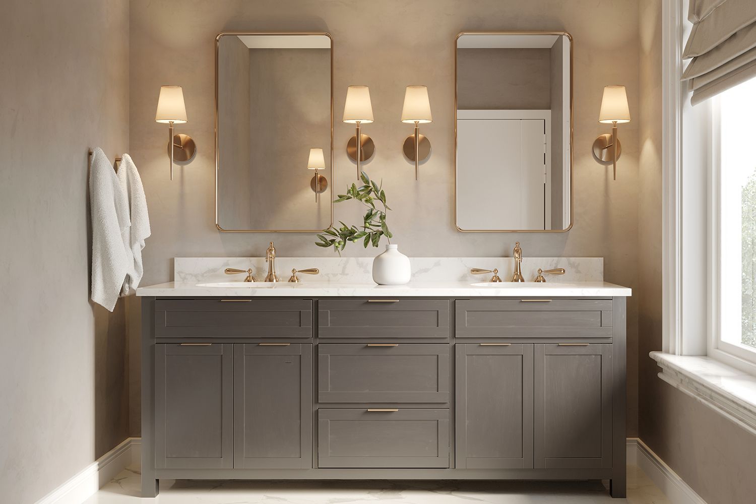 Bathroom with gray vanity, marble countertop, gold fixtures, mirrors, and sconces.