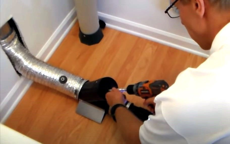 Man cleaning dryer duct at home in Michigan