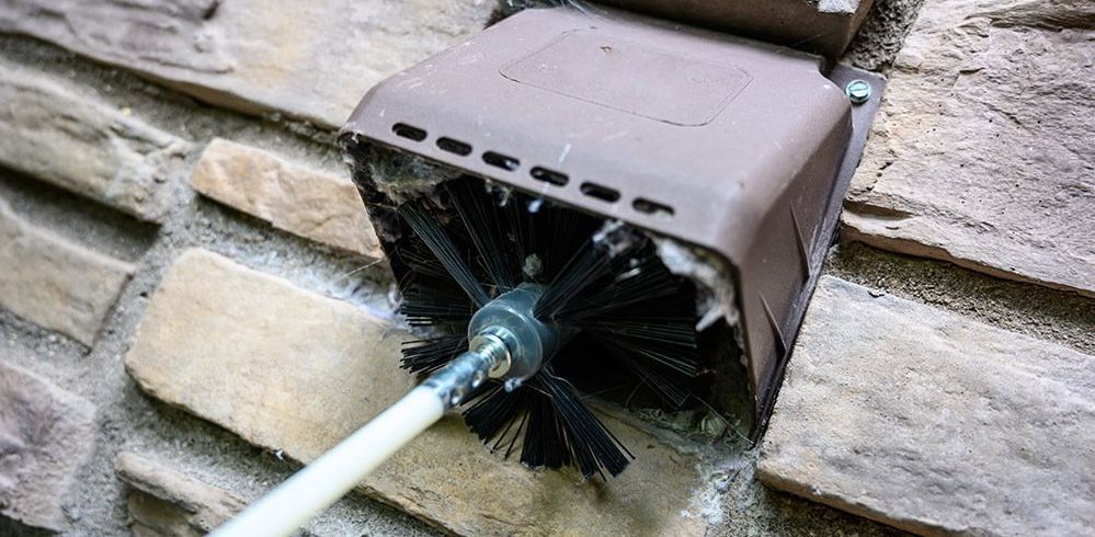 rotating brush cleaning out dryer vent outside house