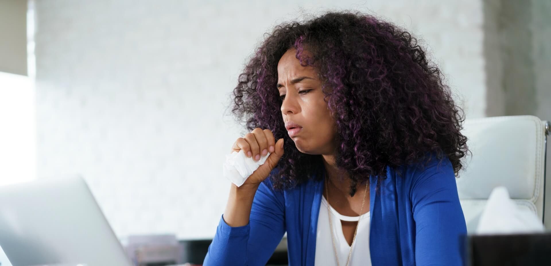 Woman coughing and not feeling well due to poor indoor air quality at home