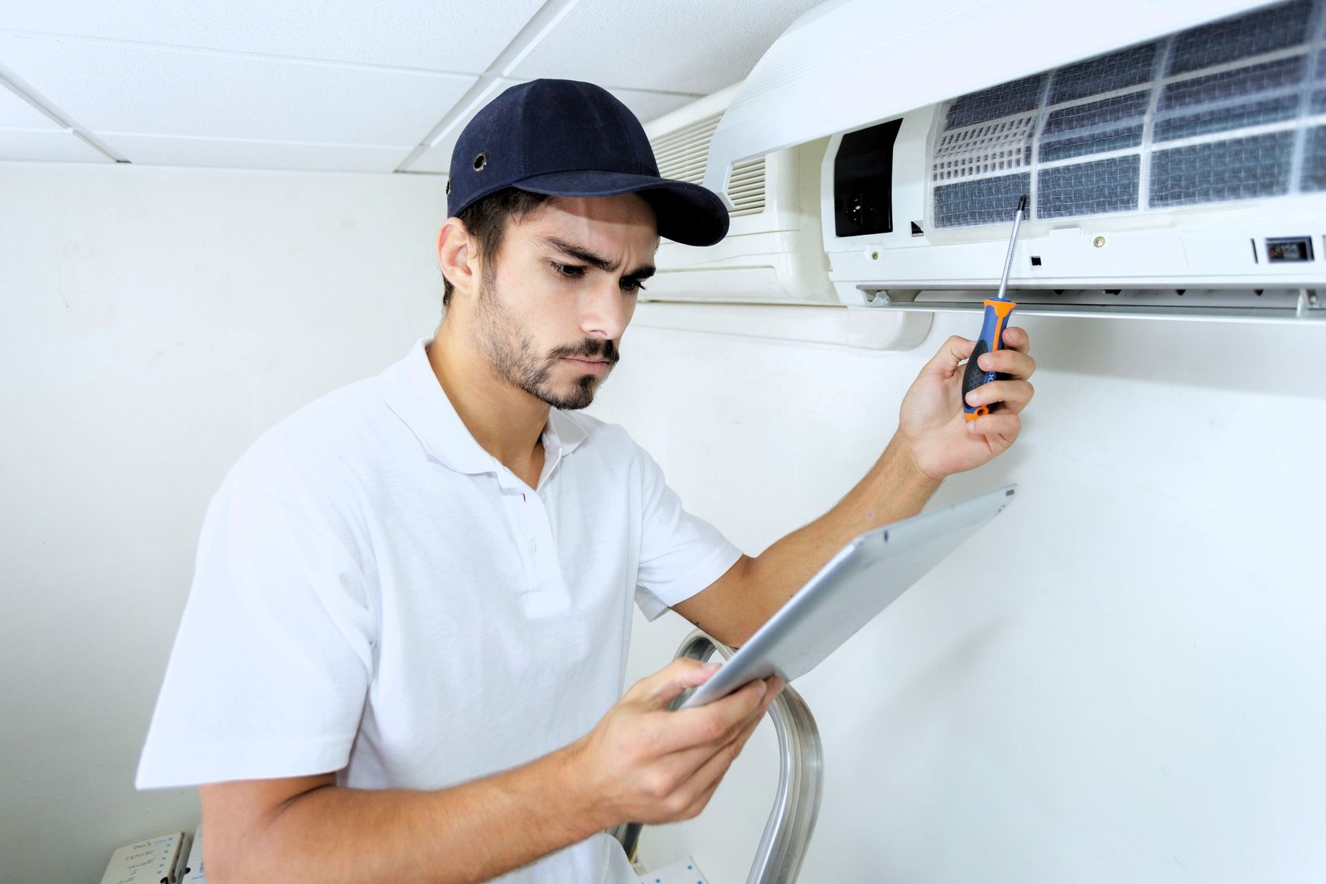 Technician checking HVAC cleaning checklist.