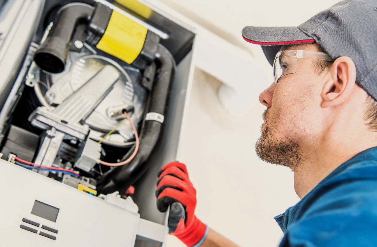 Expert technician conducts winter furnace maintenance in a Grand Rapids residence.