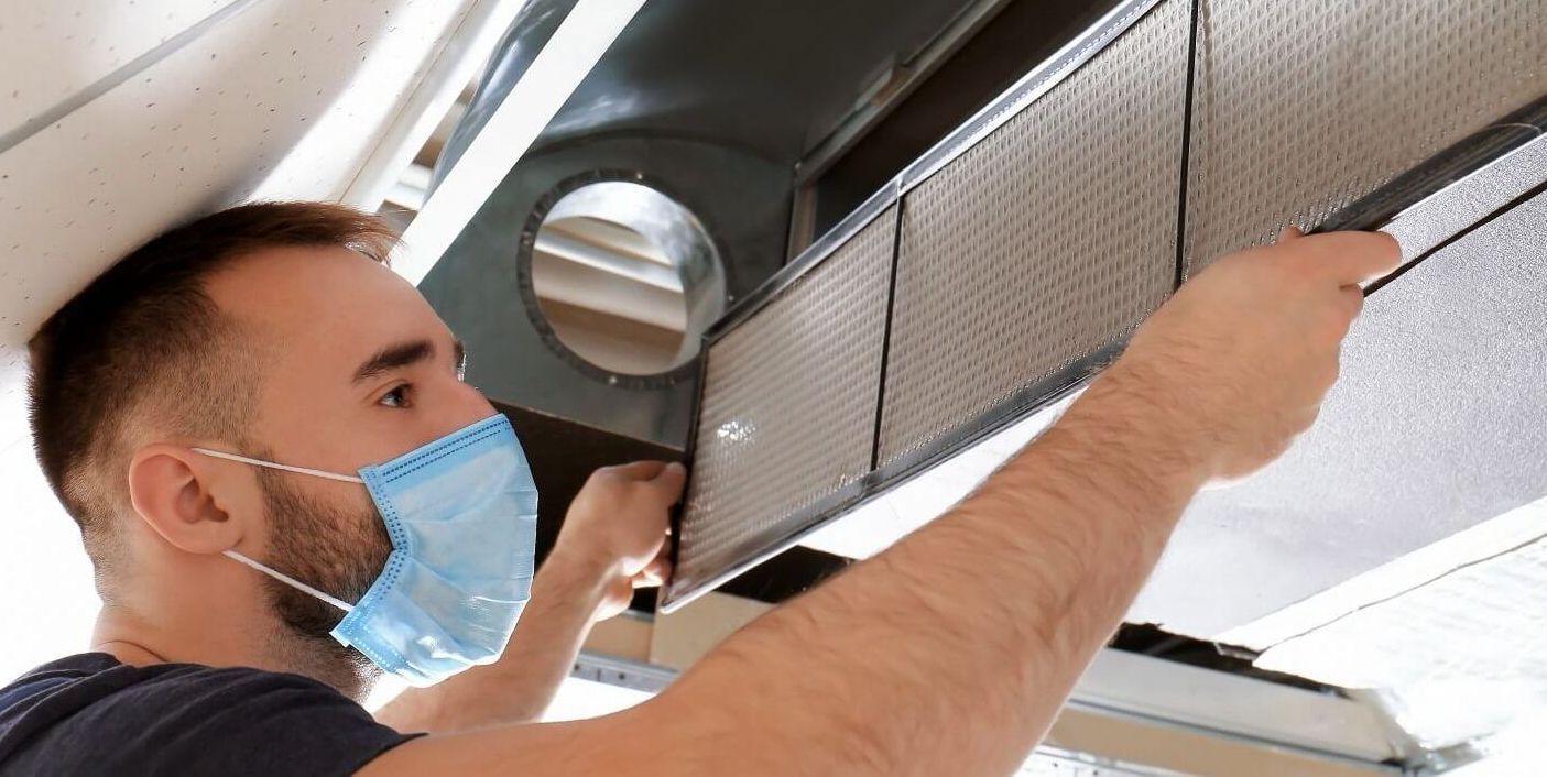 A man cleaning and sanitizing the air ducts