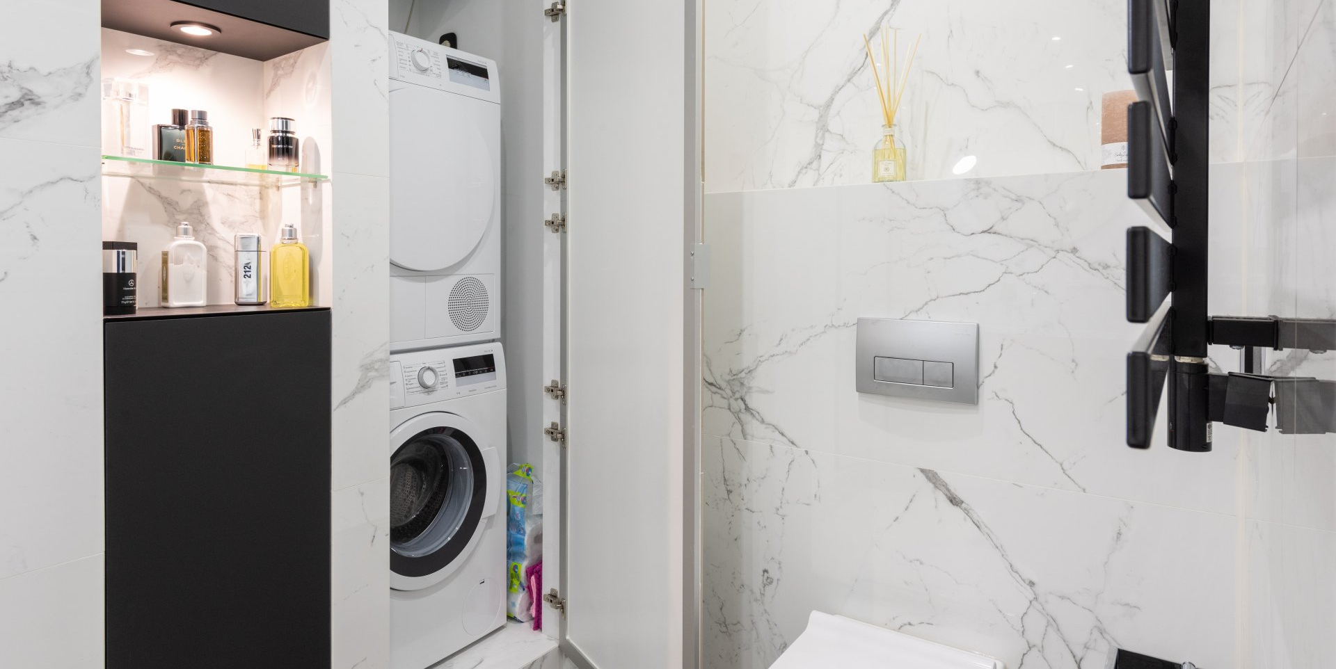 a washer and dryer combo unit in a bathroom closet