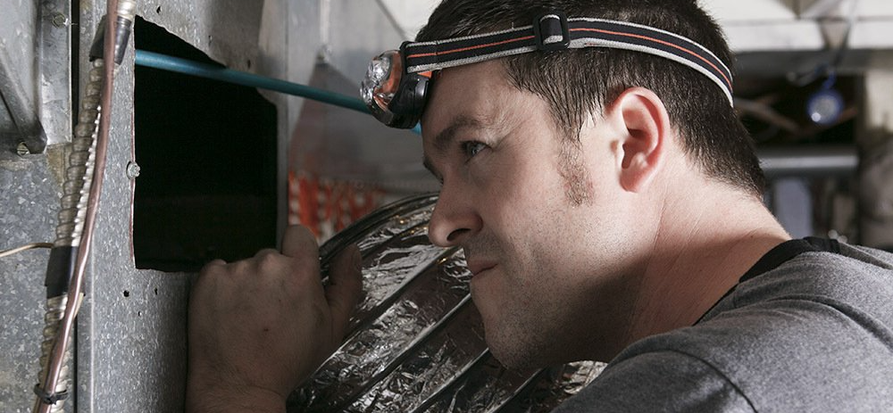duct professional inspecting duct work