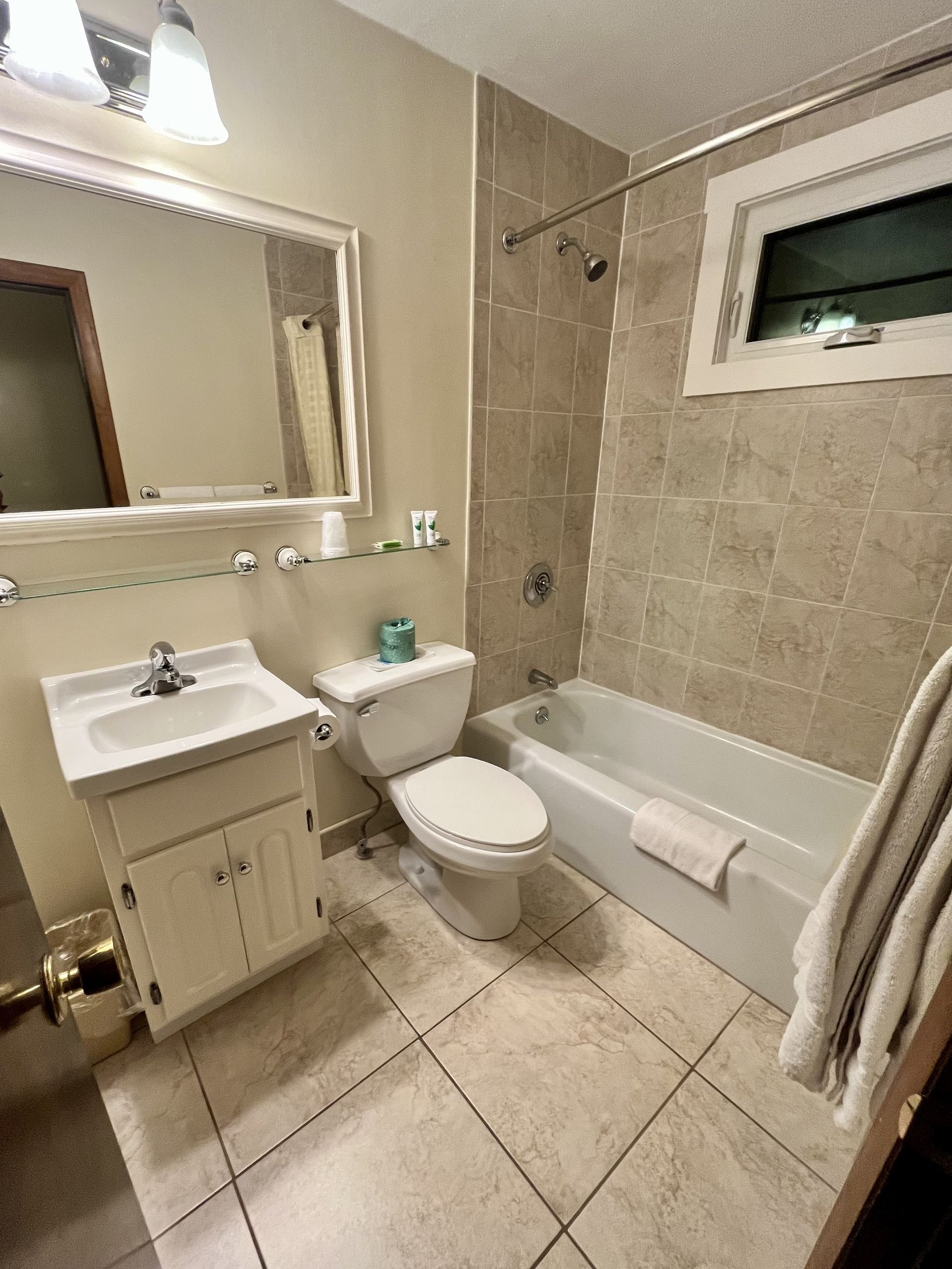 Room with two full sized beds bath