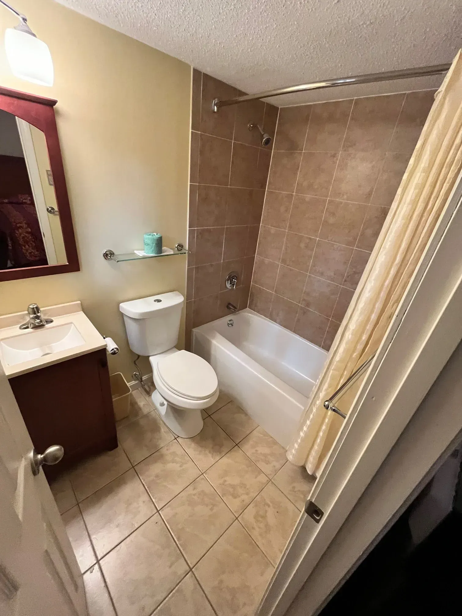 A bathroom with a toilet , sink and bathtub