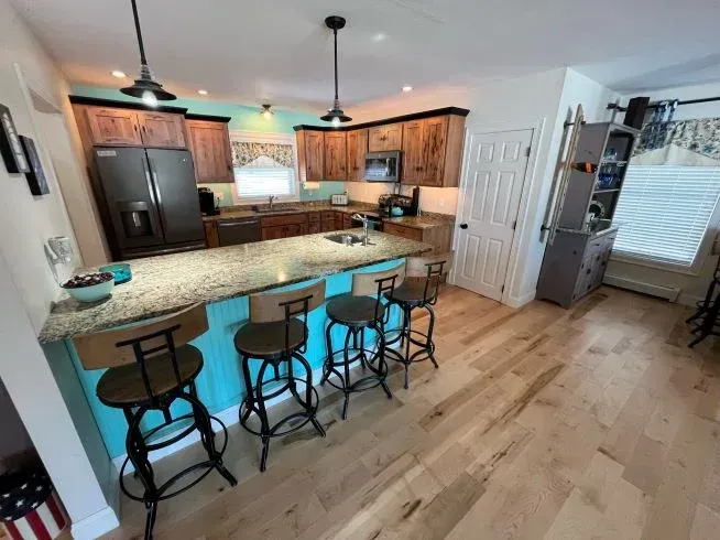 A kitchen with a large island and stools