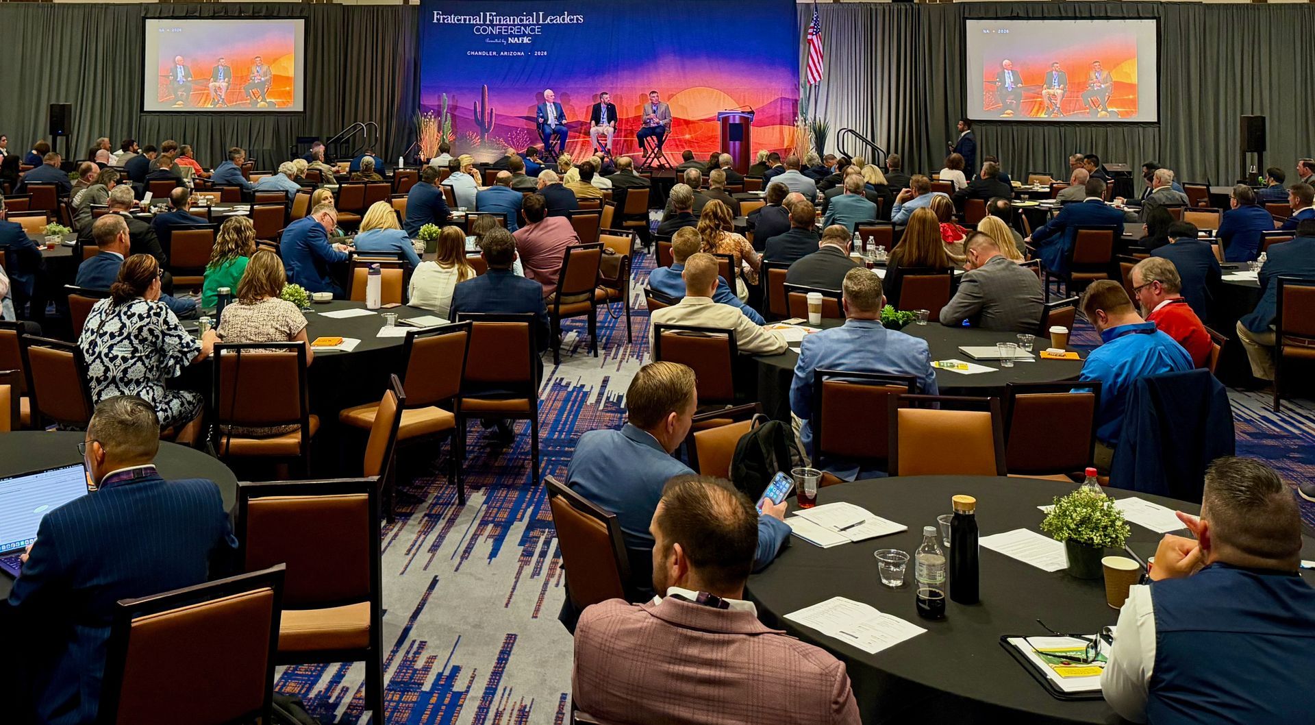 Conference attendees gathered in the ballroom for a panel discussion