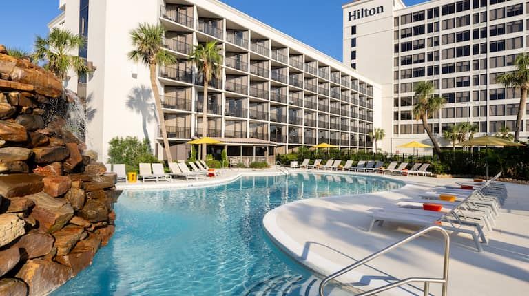 Outdoor pool and hotel buildings at Hilton Galveston Island Resort