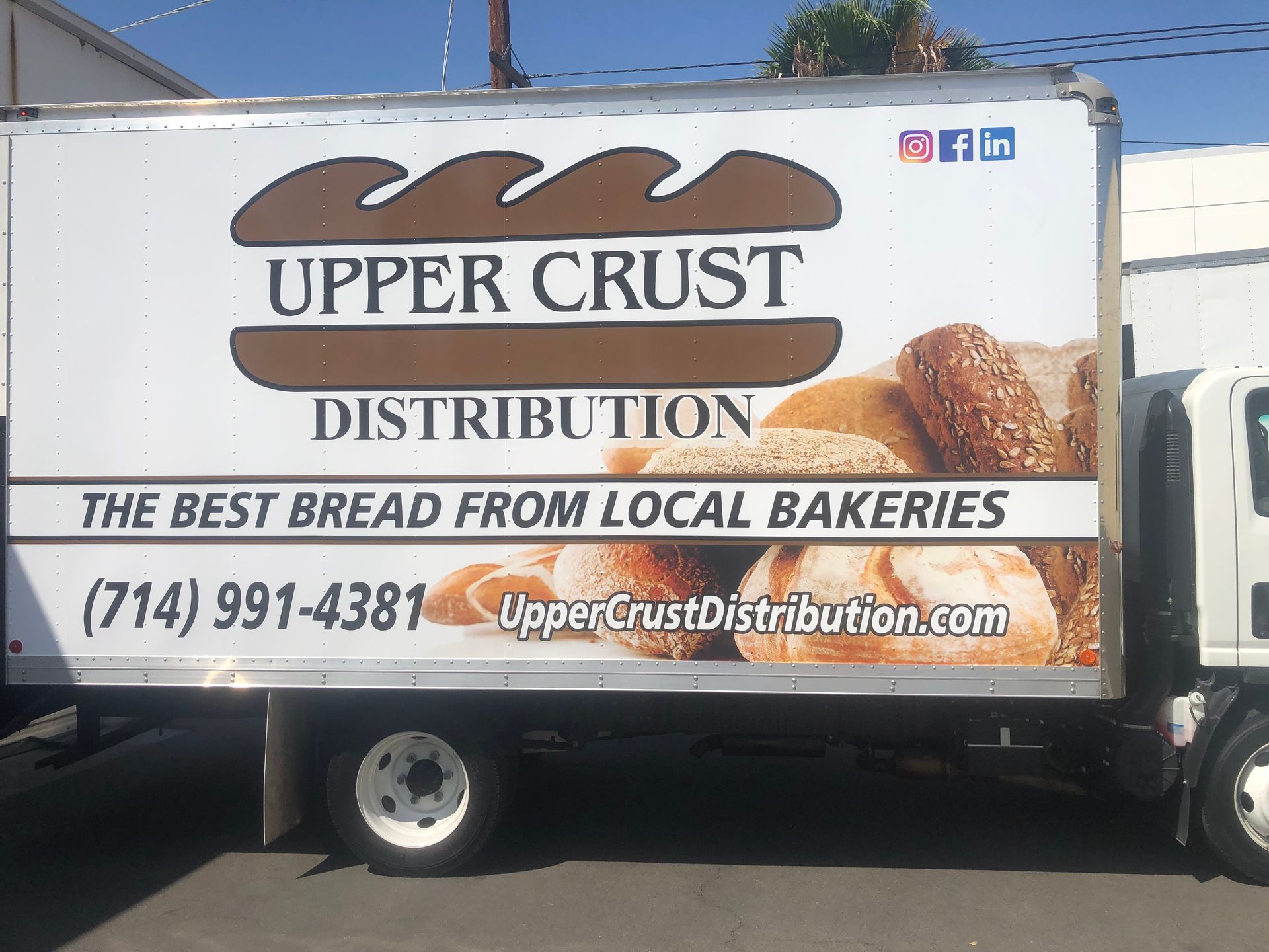 A truck that says upper crust distribution on the side