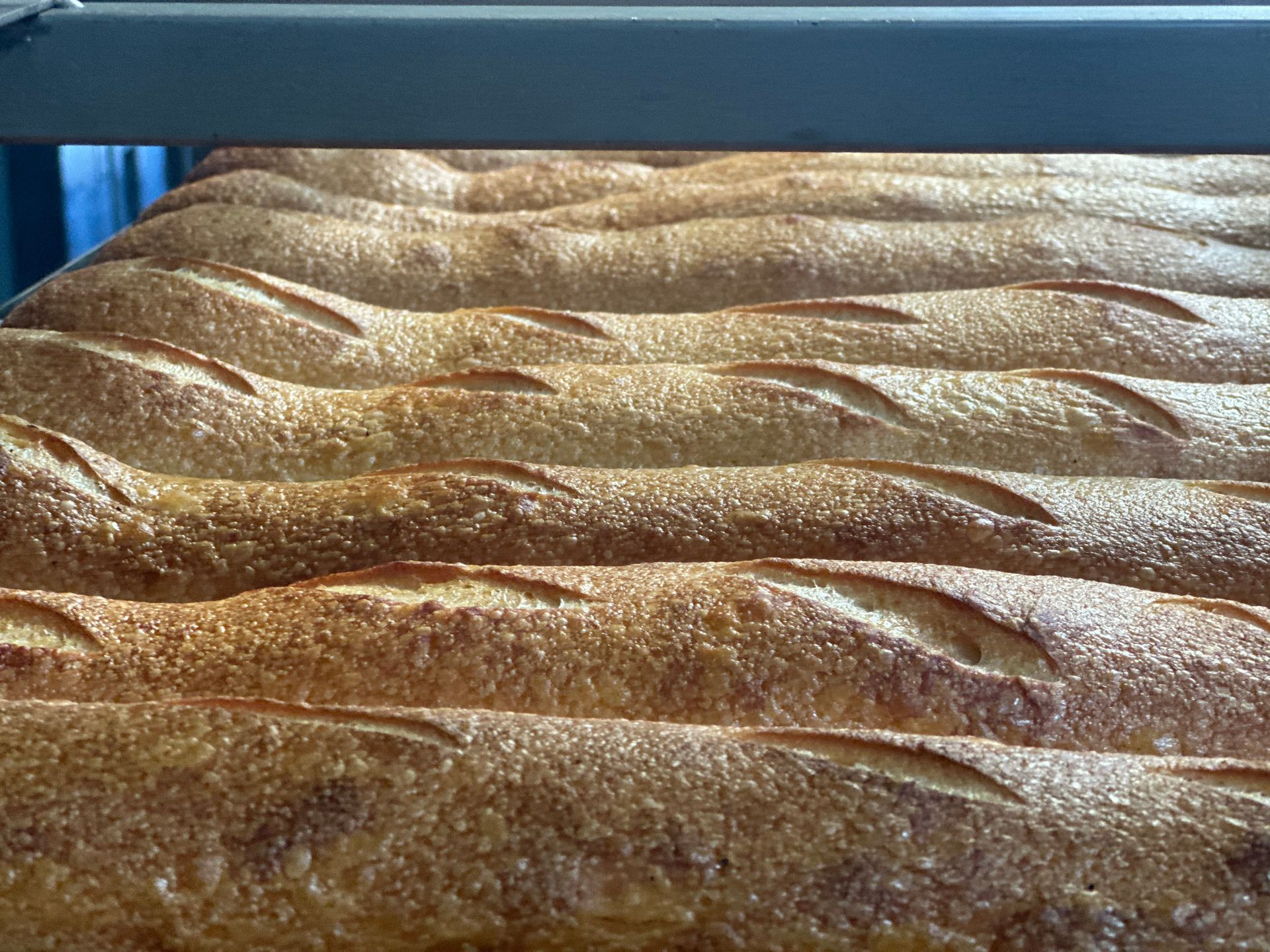 A bunch of loaves of bread are sitting on top of each other on a table.