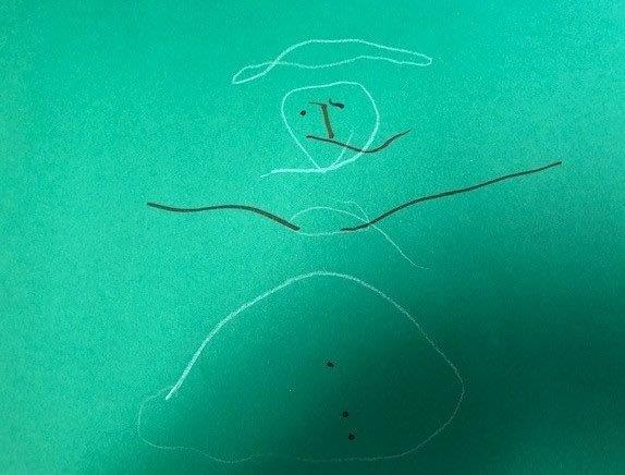A child 's drawing of a snowman with the letter i on his head