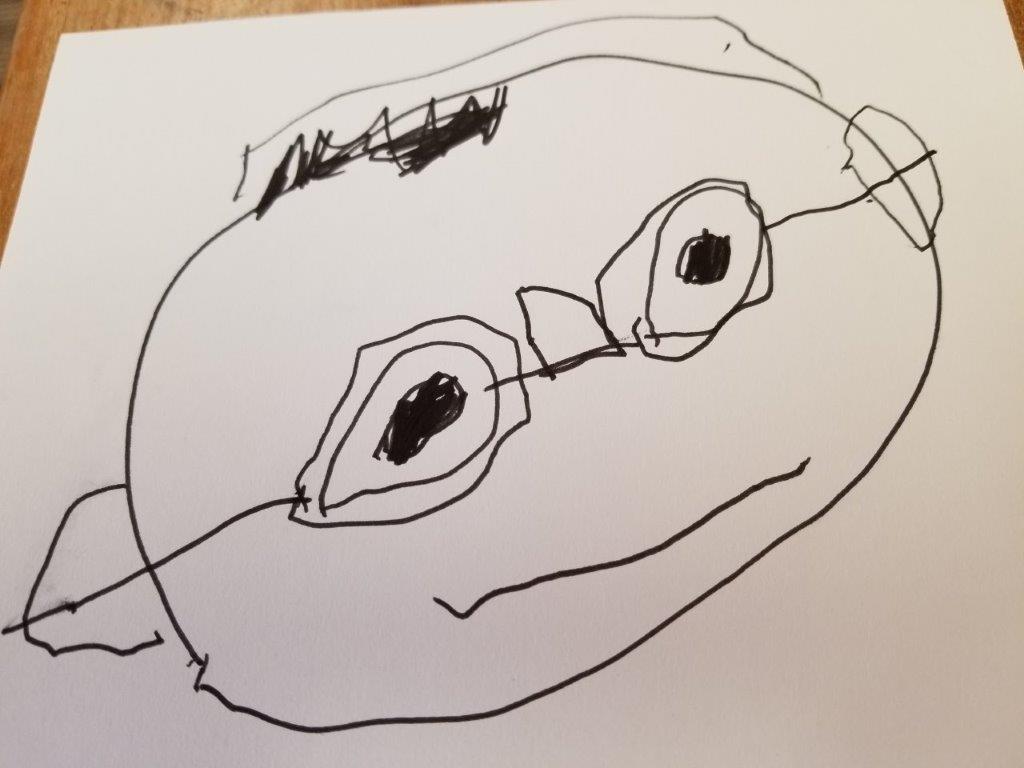 A black and white drawing of a face with glasses from a child