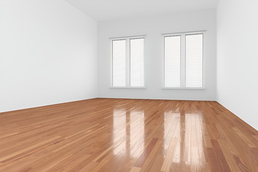 An Empty Room With A Wooden Floor And Two Windows — Kyall Chalker Floor Sanding & Polishing In North Haven, NSW
