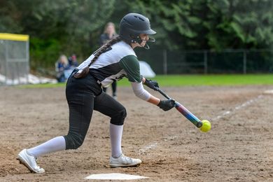Baseball player sliding into home plate, catcher in front. Blue and gold uniforms, action shot.