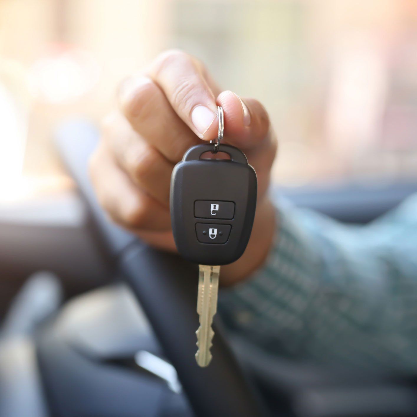 Man holding a car key