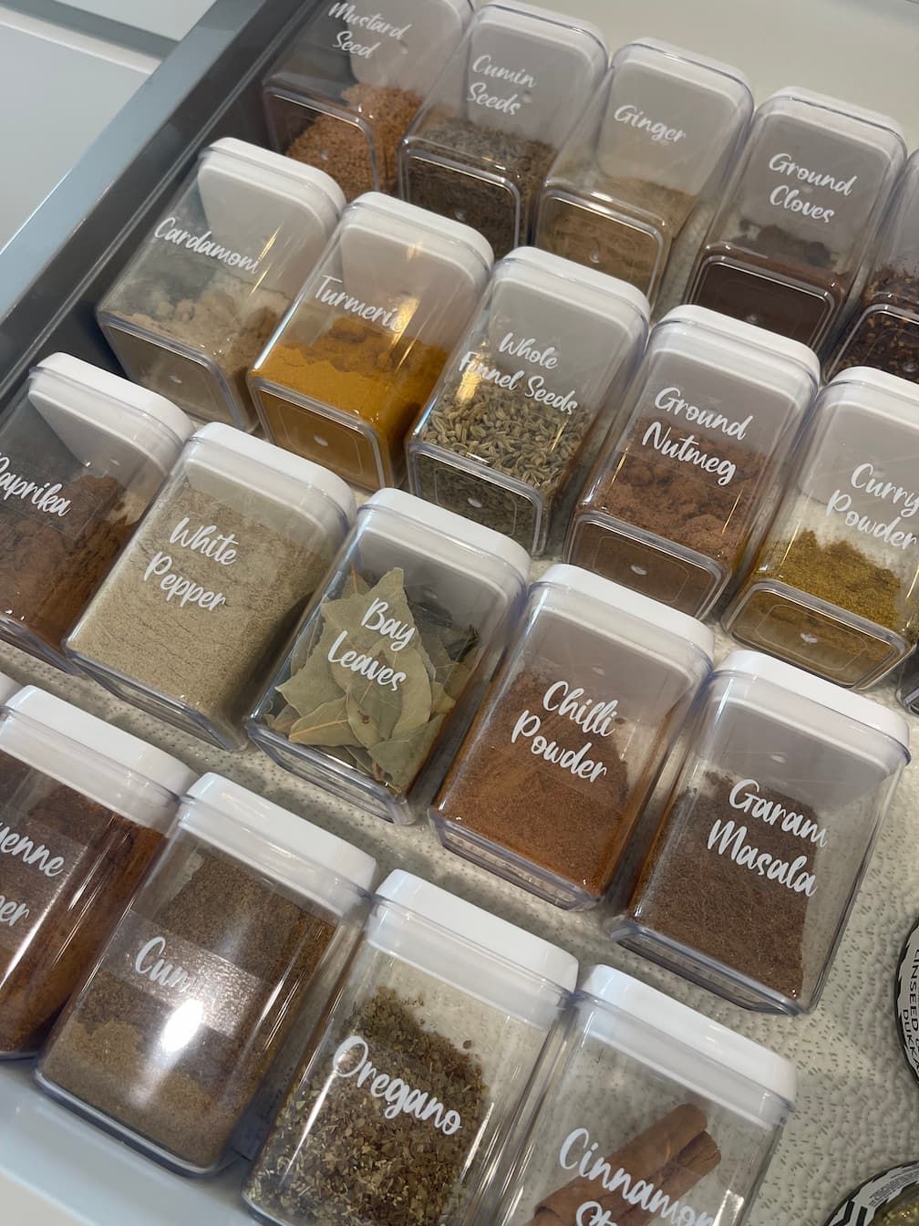 A man and a woman are standing next to each other covering their faces with their hands.