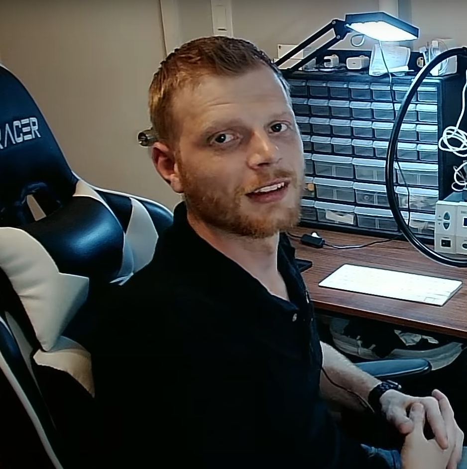 A man is sitting in a chair with the word leader on it