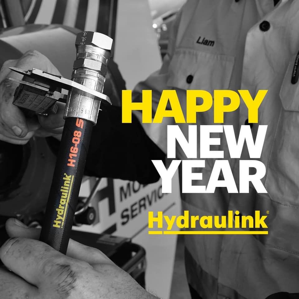 Black-and-white workshop scene with a hand holding a Hydraulink hose and bright yellow “Happy New Year” text.