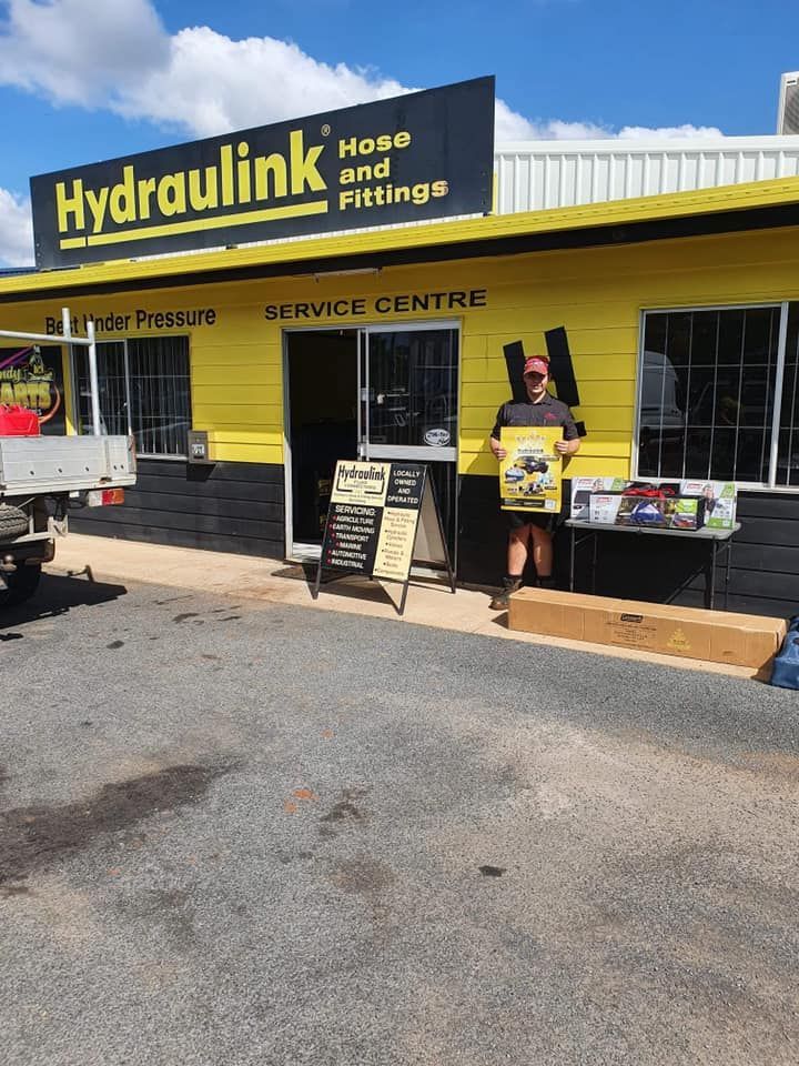 Hydraulink hoses and fittings service centre storefront with yellow sign and display tables