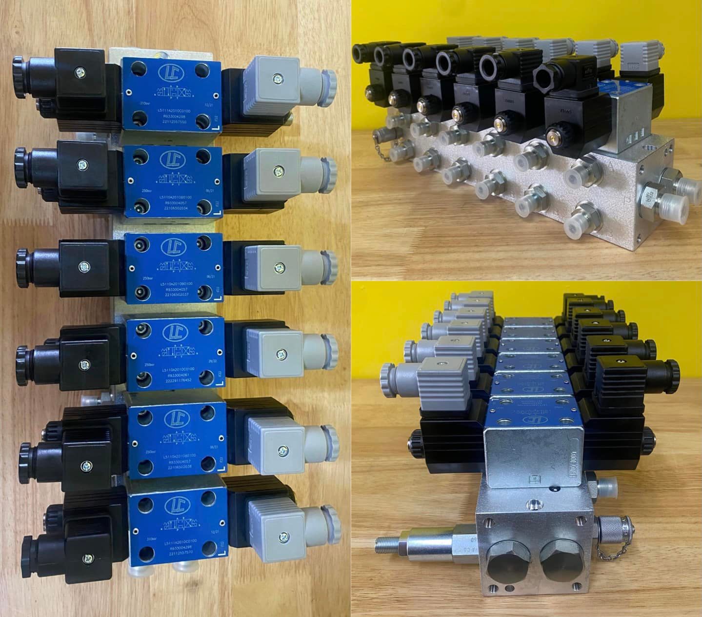 Assorted blue, black, and silver pneumatic valve manifolds arranged on a wooden surface